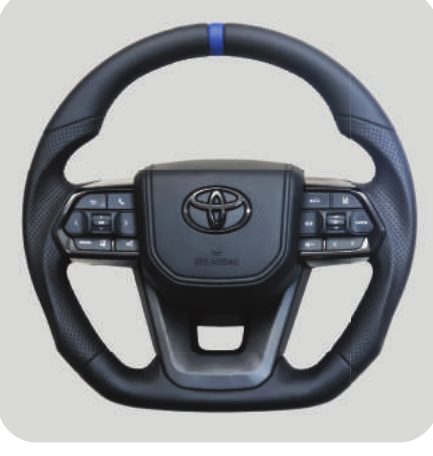 TT AUDIO LC300 STEERING WHEEL - BLACK LEATHER BLUE STRIPE